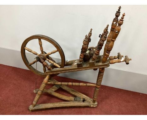 A Late XIX Century Bobbin Turned Spinning Wheel, with wool and winders and six spoke wheel, 90cm high.