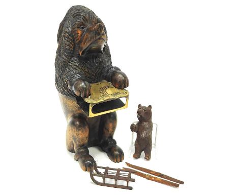 A Black Forest Style Carved Wood Model of a Dog, seated and holding a brass matchbox holder, 27cm high, and a Black Forest ca