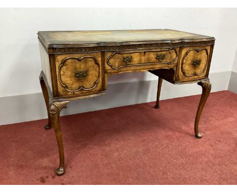 A XX Century Walnut Serpentine Shaped Ladies Desk, with leather insert, blind fret frieze over central drawer and flanking cu