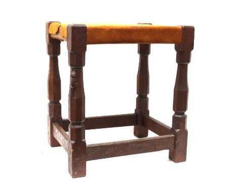 An Early Robert Thompson 'Mouseman' Oak Stool, with octagonal legs joined by four low level rails, suede seat, carved mouse s