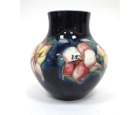 A Moorcroft Pottery Vase, of globular form with short cylindrical neck, painted in the 'Freesia' pattern against a dark blue 