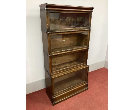 A Globe Wernicke Oak Four High Sectional Bookcase, (bearing label), on a shaped plinth base, 172cm high, 86cm wide. Polish lo