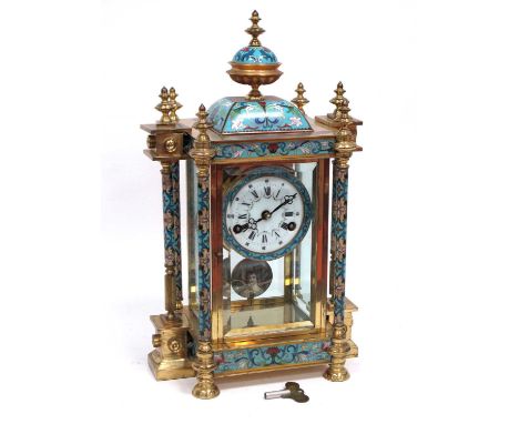 An Early XX Century Gilt Metal and Champlevé Enamel Mantle Clock, with four glass panels flanked by six columns, the domed to