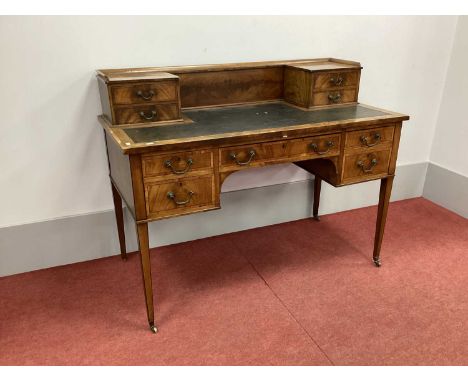 An Edwardian Writing Desk, with three-quarter gallery over flanking two drawers, black sciver, central drawer with flanking d