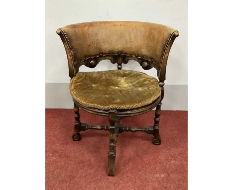 1930's Tub Chair, with leather back rail and caned seat on turned supports with scroll feet united by an 'X' stretcher.