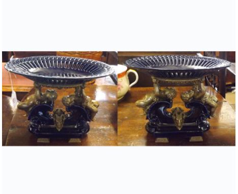 A pair of blue glazed and ormolu Tazzas, the oval pierced bowl supported by two cherubs, raised on a blue ceramic base with r