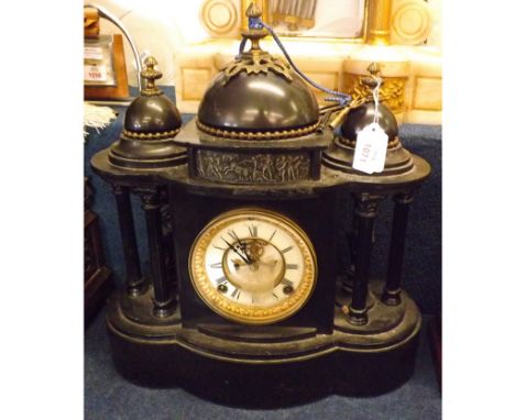 A 19th Century Black Slate Mantel Clock of architectural form, the cased three dome top and pillared side supports raised on 