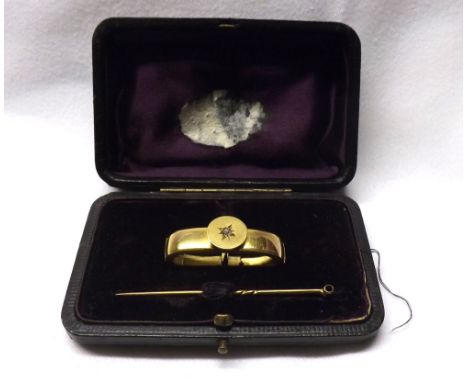 Cased Victorian unmarked Gold scarf clip of oval hinged form set to the front with a single small old cut Diamond.  The front