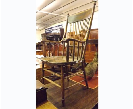 A late 19th/early 20th Century Stick Back Elm Seated Carver Chair raised on turned legs with double stretchers, 21” wide 