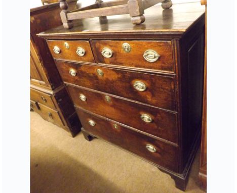 A late 18th/early 19th Century Oak Chest of two short and three long drawers with oval brass plate handles, raised on bracket