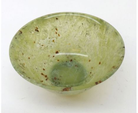A small circular Jade Bowl of tapering form, with a slightly everted rim and short foot, 4” diameter 