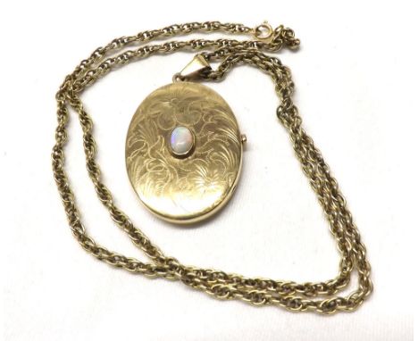 A hallmarked 9ct Gold Oval Locket, the floral and foliate engraved front set to the centre with a small oval Opal and mounted