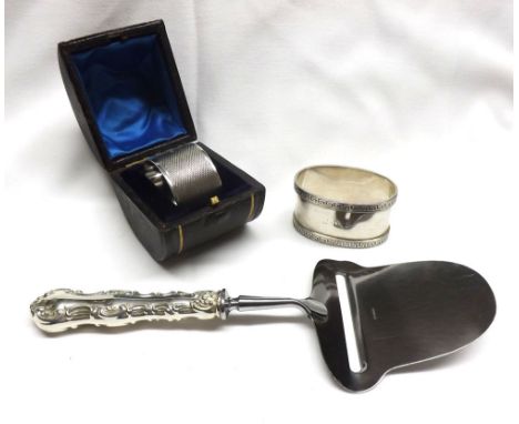 A Leather Cased Single Silver Serviette Ring, engine-turned decoration, probably Birmingham 1931; a further White Metal Napki