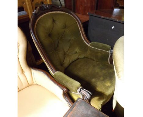 A Victorian Mahogany Framed Button Back Armchair, upholstered in green, the scroll arms to cabriole legs with ceramic castors