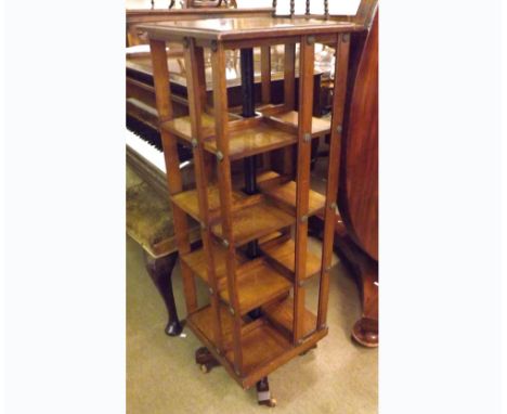 A late 19th/early 20th Century Oak square formed revolving Bookcase, fitted with four shelves, raised on a quatre base, with 