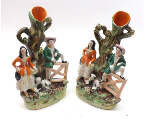 A Mixed Lot: two small Staffordshire Spill Vase Group, both modelled as two figures beside a gate and tree trunk, decorated t