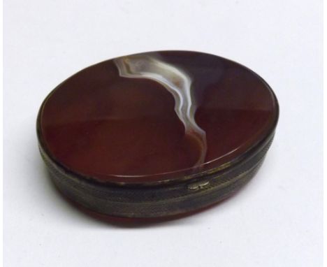 A Victorian Gilt Metal and Cornelian panelled Snuff Box, oval shaped, 2 ½” x 2”