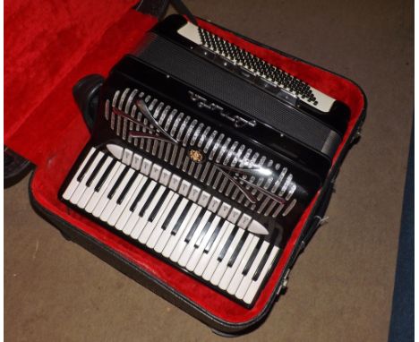 A mid-20th Century Fonola one hundred and twenty button Piano Accordion, central paper-covered bellows, twenty-four keys plus