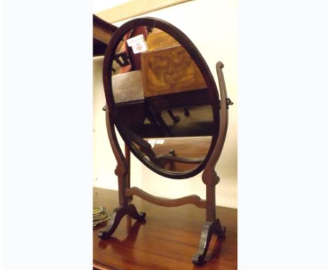 A small 19th Century Mahogany Oval Dressing Table Mirror on adjustable support, 14 ½” wide