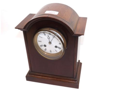 An Edwardian Mahogany Arched Cased Mantel Clock, the plain case raised on a plinth base, the 3 ½” white enamel Arabic dial wi