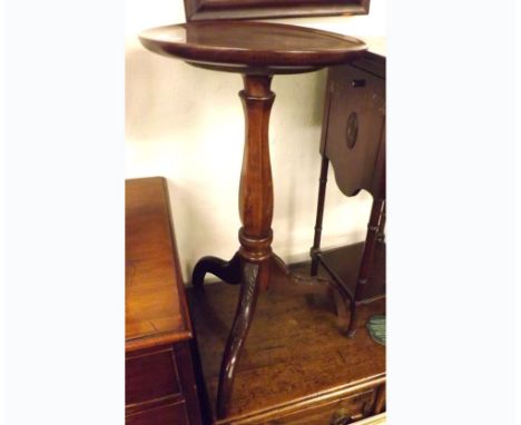 A Mahogany pedestal Table with circular top, raised on a tulip baluster support, terminating in tripod base moulded with foli