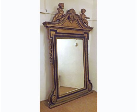 An extremely large Giltwood and Ebonised Framed Overmantel Mirror, the arched top with cherub, shell and flower detail, sides