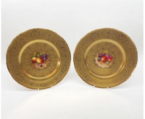 A pair of mid- 20th Century Royal Worcester Plates, the centres well painted in colours with panels of fruit within ornate gi