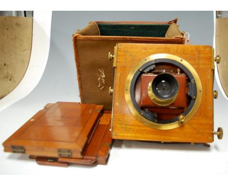 A late 19th century mahogany and brass mounted plate camera, and accessories in fitted canvas covered case
