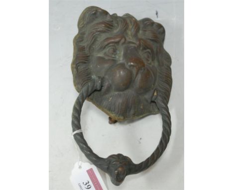 A brass lion mask door knocker **NOT BRONZE**