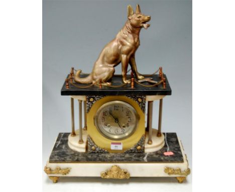 A late 19th century French marble mantel clock of architectural outline, surmounted by a German shepherd, having silvered dia