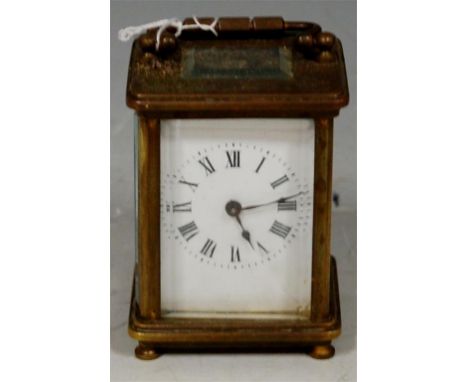 An early 20th century French brass miniature carriage clock, having a white enamel dial with Roman numerals and visible platf