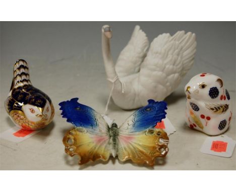 A Karl Ens porcelain butterfly, a Lladro porcelain swan ornament No. 6175,  and two Royal Crown Derby porcelain table ornamen