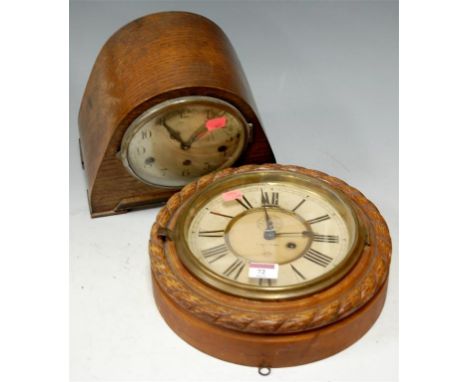 An early 20th century wall clock in oak ropetwist surround, together with a 1930s oak cased mantel clock (2) 