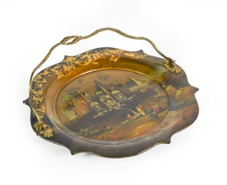 A Victorian Papier Mache Cake Plate, shaped circular, the centre with a mother-of-pearl inlaid and painted scene of figures i