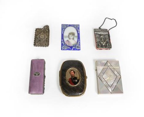 A collection of various metal mounted cases, including: one with a portrait of Napoleon III on the cover; another with purple