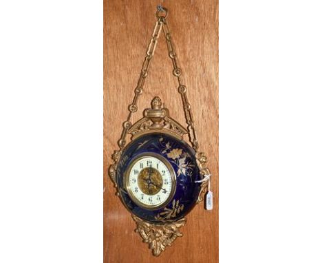 A gilt metal and enamel wall timepiece