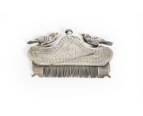 A White Metal Moustache Comb, Possibly Indian, with two exotic bird finials, with compartment for liquid, 8.5cm wide 