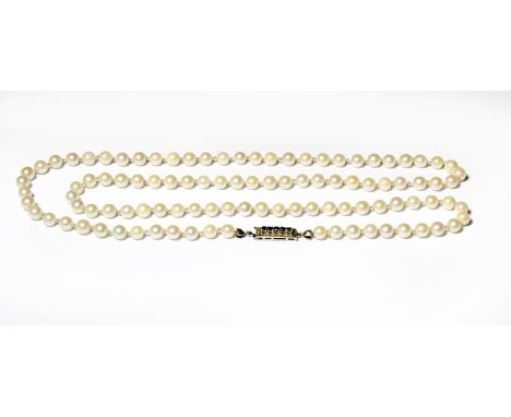 A cultured pearl necklace knotted to a sapphire clasp stamped '750', length 81.5cm .  Gross weight 37.7 grams.