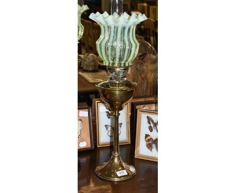 A Victorian brass oil lamp with a vaseline shade, 66cm overall including funnel.  Few fleabite chips to the base of the shade