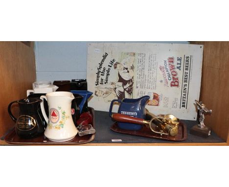 A group of advertising wares including a Newcastle Brown Ale enamel sign, various beer, cognac and other water jugs, a brass 