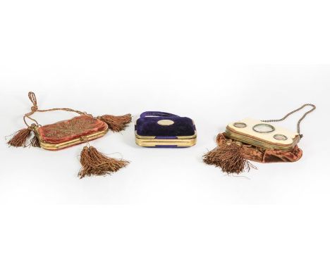 Three Brass-Mounted Velvet Purses, two cartouche shaped and with tassels, one stitched with foliage the other with a bone pan