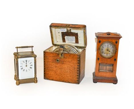 A pigeon timing clock, compass, Art Nouveau mantel timepiece, and a brass carriage timepiece
