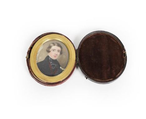 Continental School, an oval portrait miniature on ivory of a young gentleman in black coat, in brass frame with matted finish