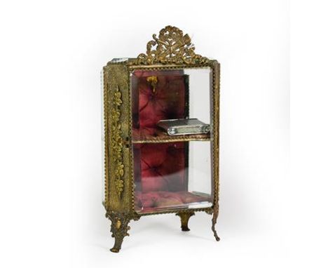 A Gilt-Metal Mounted Miniature Display Cabinet, on scroll feet, with ribbon-tied love trophy finial, the interior velvet line