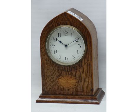 Edwardian inlaid oak arched top mantel timepiece, circular silvered Arabic dial, barrel movement stamped with lion trademark 