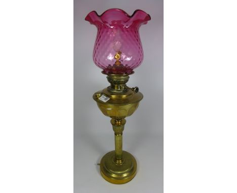 19th/ early 20th Century brass oil lamp with cranberry glass shade converted to electric     Condition Report   Click here fo