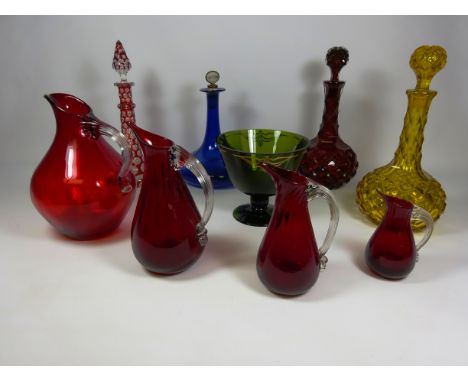 Graduated set of four red glass jugs with clear handles, red overlay decanter, pair of red & amber facet cut decanters, ships