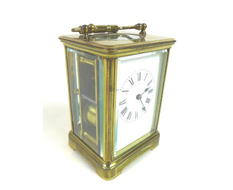 A 20th century brass carriage clock, with enamel dial and Roman numerals, blued steel hands, five glass gilt brass case with 