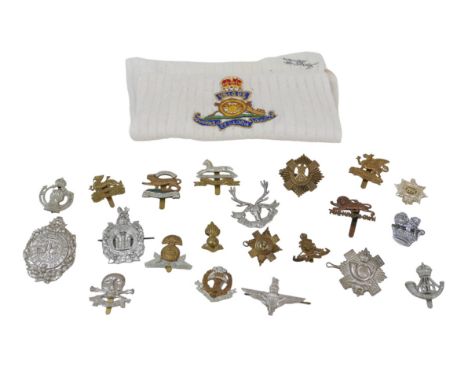 A collection of twenty-one British army cap badges,&nbsp; together with assorted coins and tokens, including some silver cont