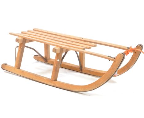 Davos - A vintage 20th century wooden sled / toboggan, with metal runners and stamped 'Davos' to one of the slats. With an ad